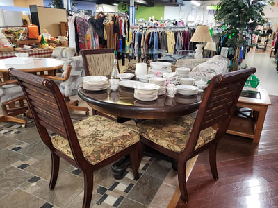 Resale Stores link. Image of furniture, clothing and dishes sold at one of the resale stores.
