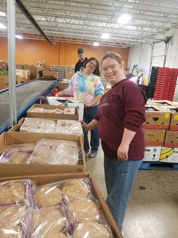 Persons receiving services volunteering at the Genesee County Food Bank of Michigan.