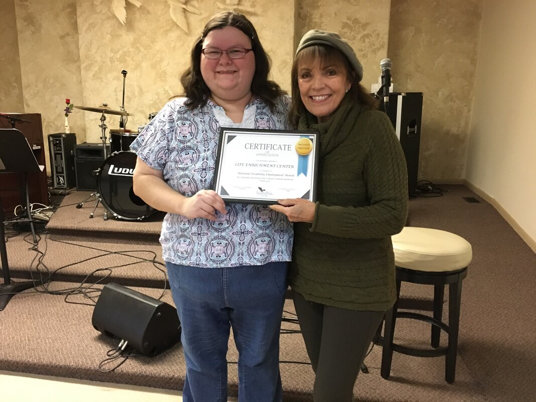 Presenting Holly church with a diverse employment certificate.