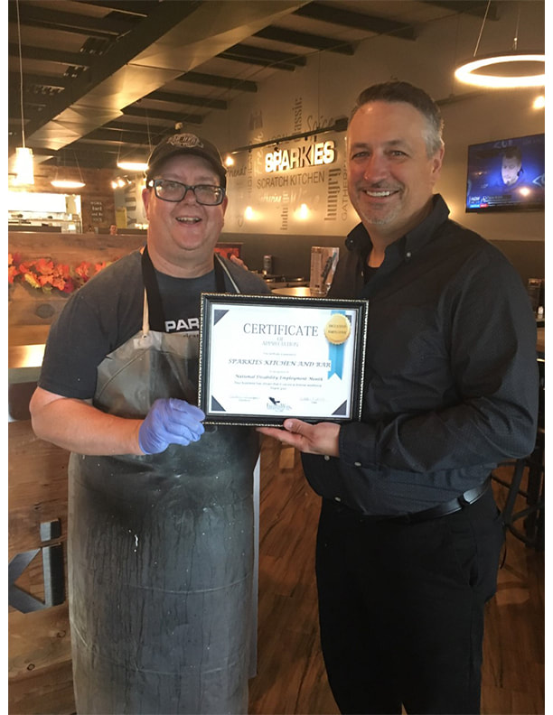 Presenting Sparkies Bar and Grill with a diversity employment certificate.
